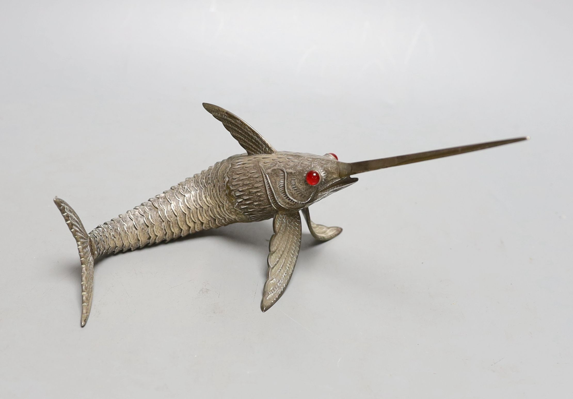 A 20th century Spanish articulated model of a swordfish, with red glass eyes, approx. 26.5cm, gross weight 118 grams.